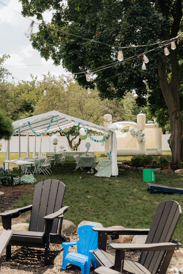 Backyard party setup with tent and tables